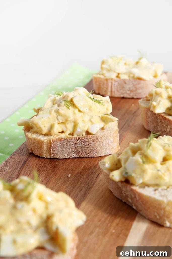Angled view of Deviled Egg Bruschetta sitting on wood board