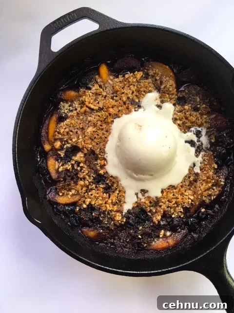 Warm peach and blueberry crisp in a skillet