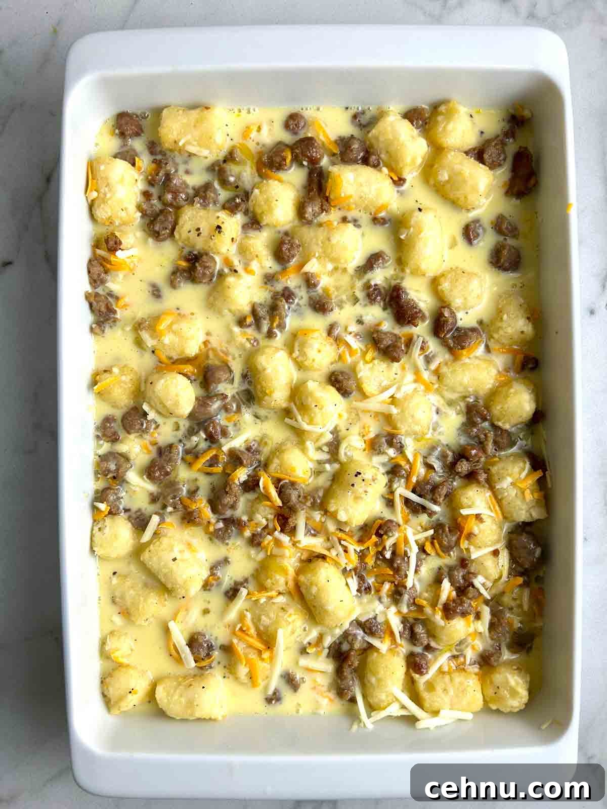 Cheesy Sausage and Tater Tot Breakfast Casserole Recipe 8 milk and egg mixture poured into casserole dish.