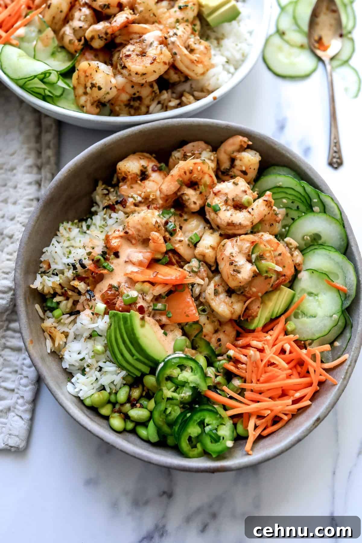 Grey bowls with Shrimp Poke Bowl ingredients. Chopsticks on the side.
