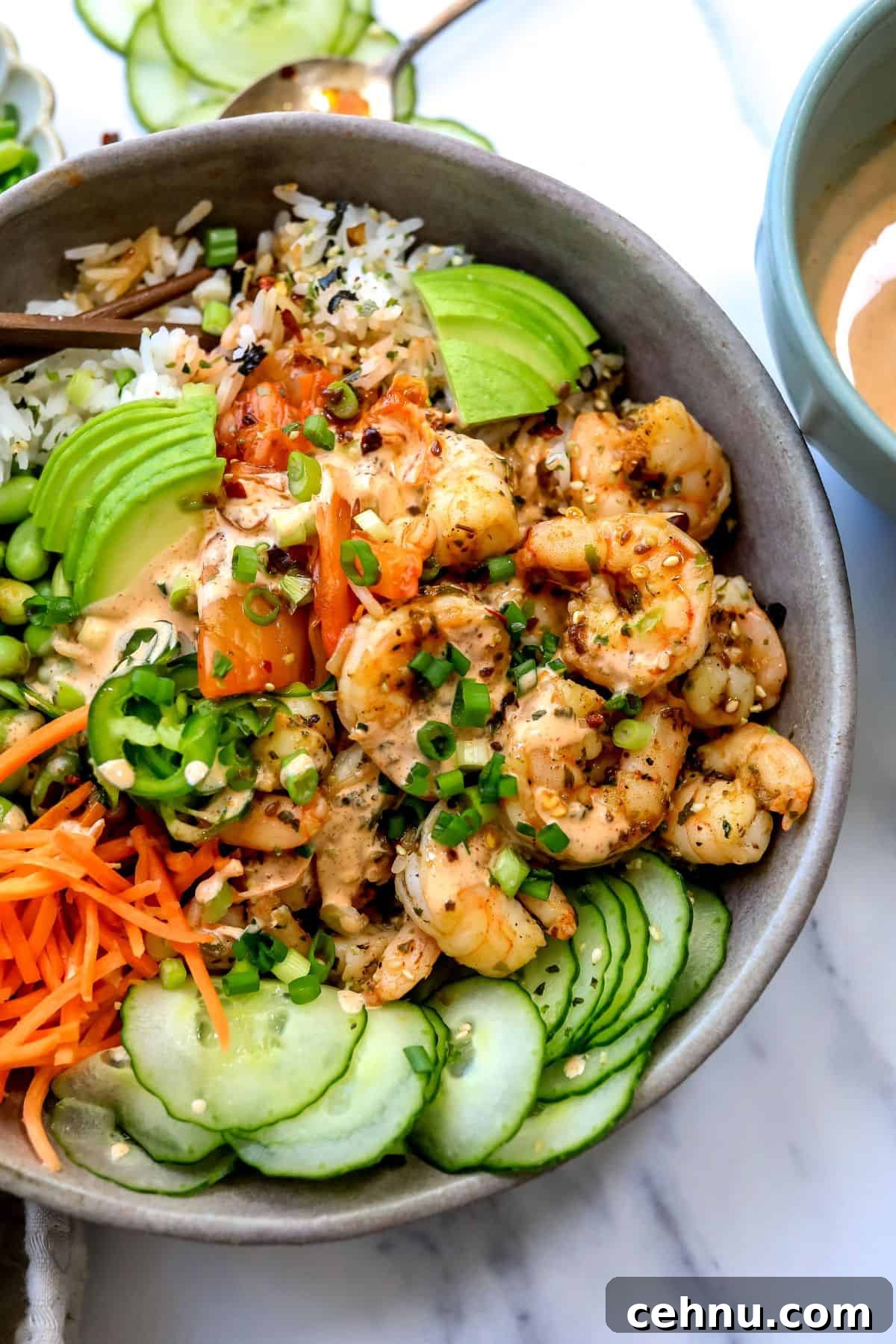 Grey bowls with Shrimp Poke Bowl ingredients. Chopsticks on the side up close.