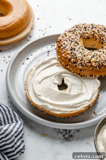 Smooth cream cheese spread on a bagel.