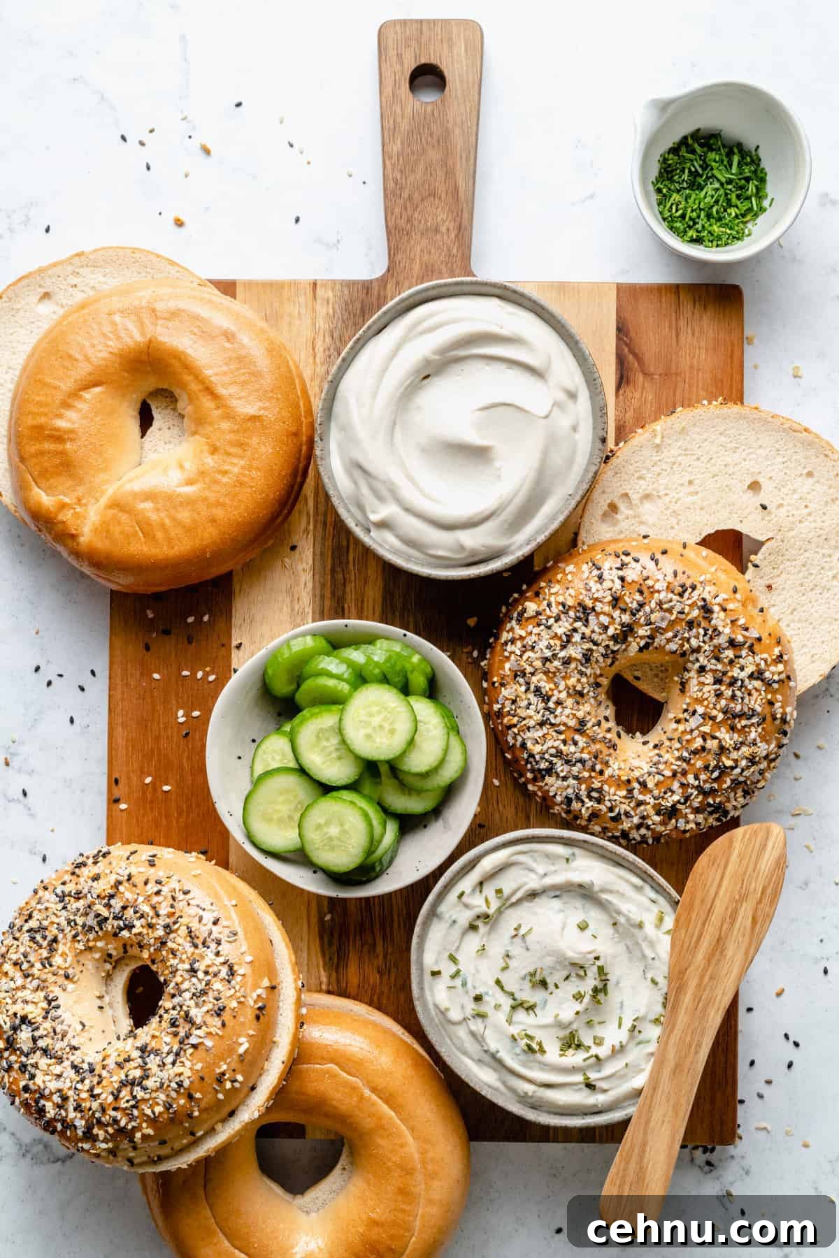Bagels with cream cheese and cucumber slices.