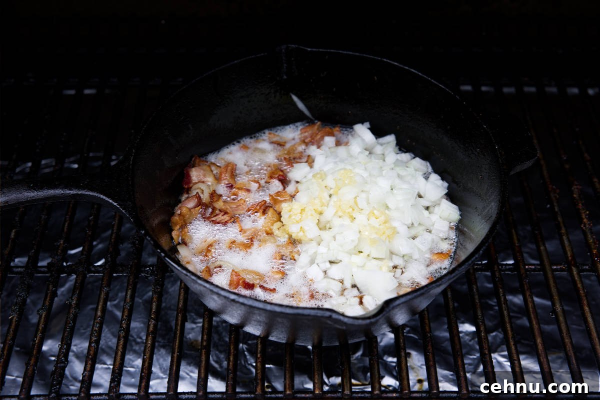 Crispy Smoked Brussels Sprouts Recipe 6 bacon, onions, and garlic cooking in the cast iron skillet