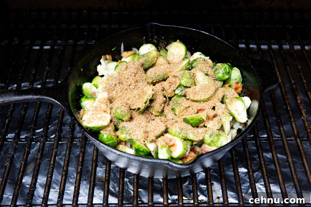 Crispy Smoked Brussels Sprouts Recipe 7 brussels sprouts in a skillet with seasoning sprinkled on top