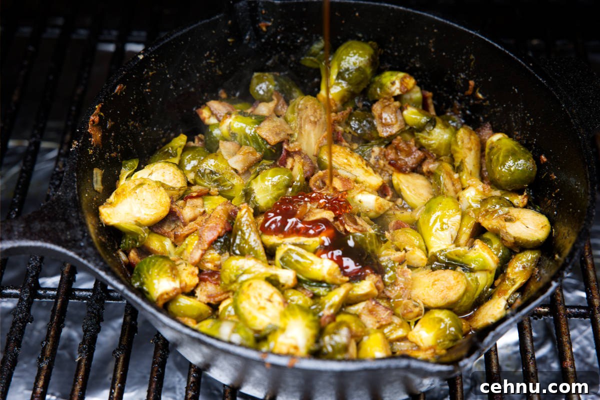 Crispy Smoked Brussels Sprouts Recipe 8 smoked brussels sprouts in a skillet with a drizzle of honey added