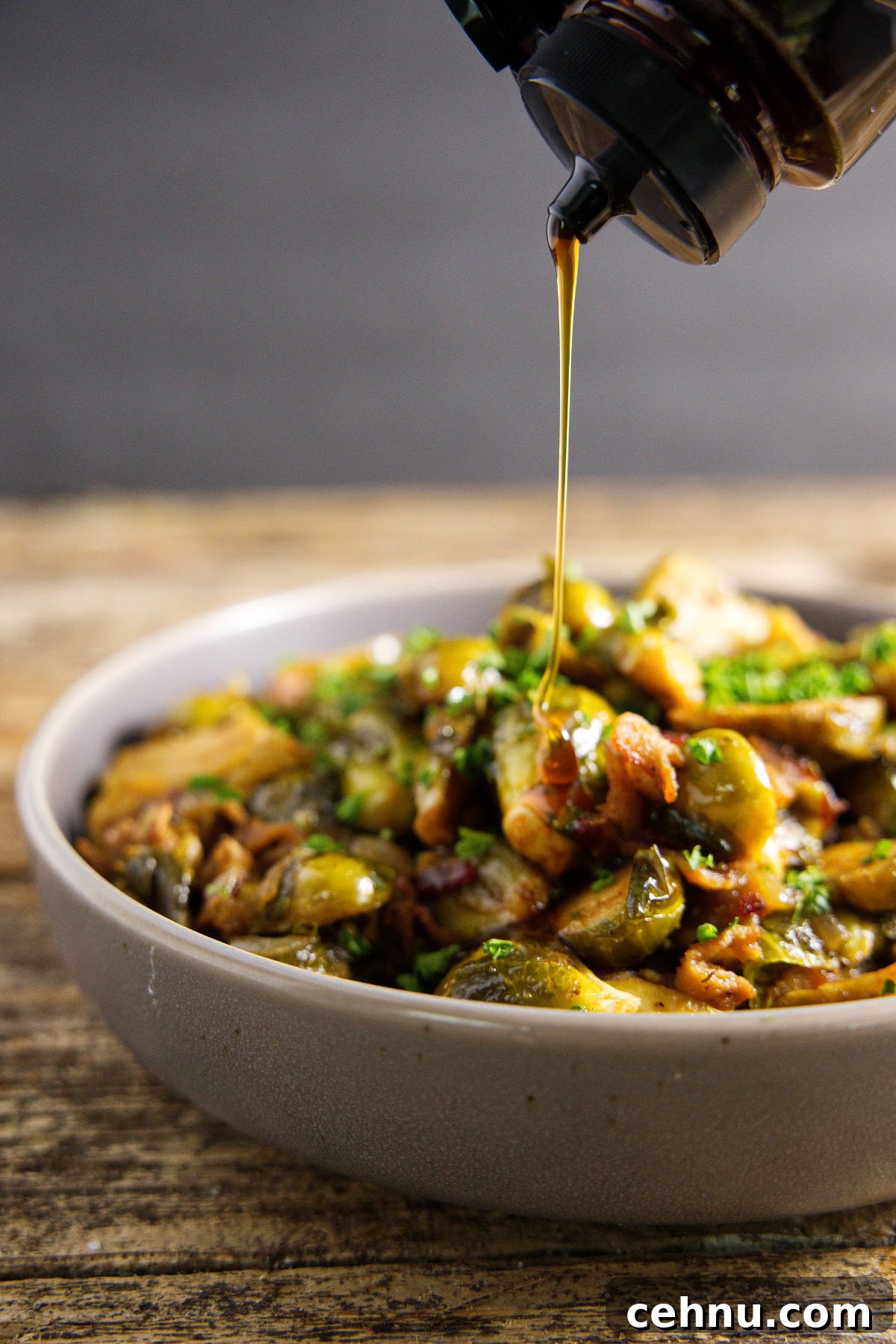 Crispy Smoked Brussels Sprouts Recipe 10 drizzle of honey falling on top of smoked brussels sprouts in a bowl