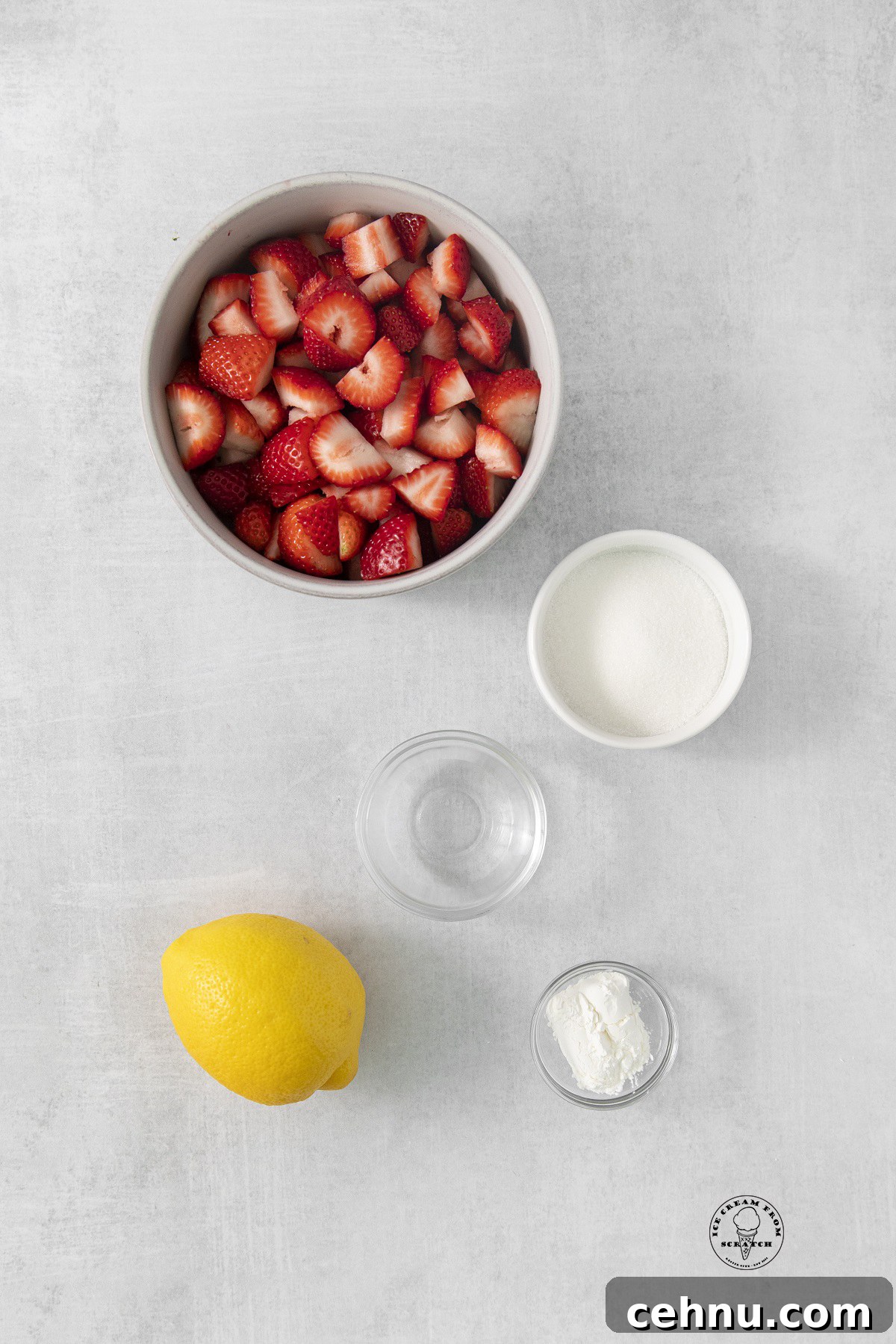 the ingredients for strawberry compote, including fresh berries, sugar, and lemon.