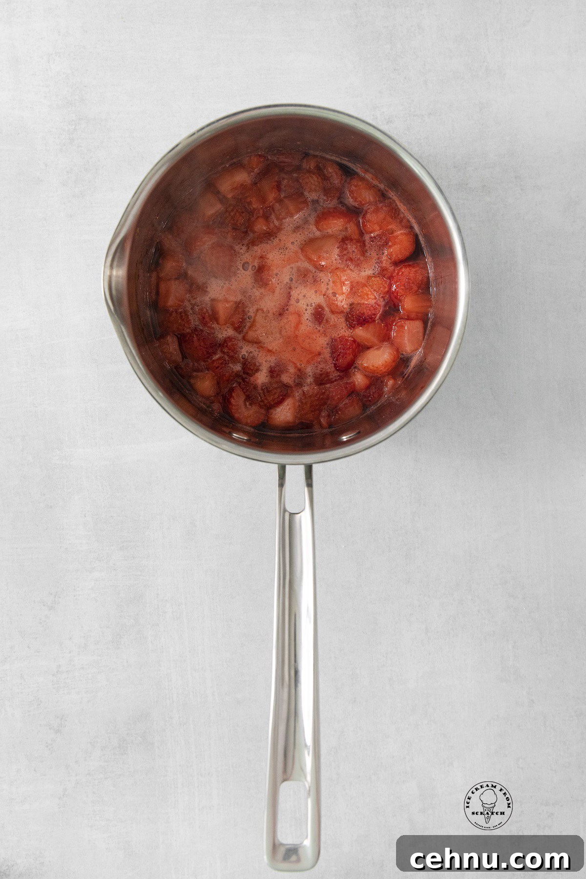a saucepan of cooked strawberries. 