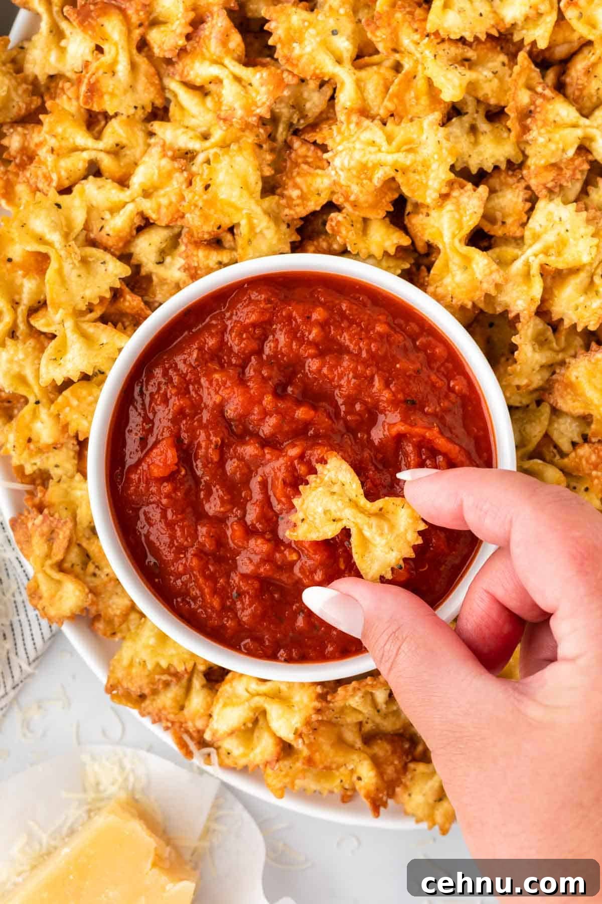pasta chips next to a bowl of marinara for dipping
