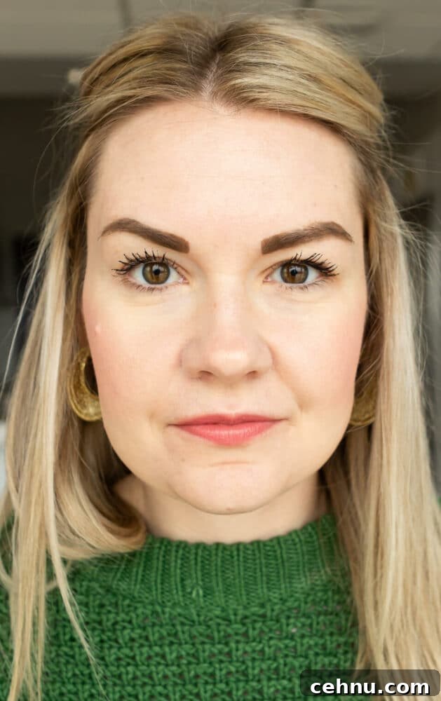 Clean Mascara for Longer Lashes Without Harsh Ingredients 3 Headshot of Lauren wearing a Kelly green sweater not smiling.