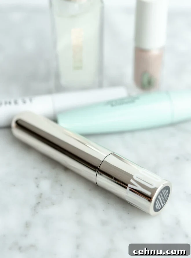 Clean Mascara for Longer Lashes Without Harsh Ingredients 6 Beautycounter mascara on a gray and white marble surface with other makeup in the background.