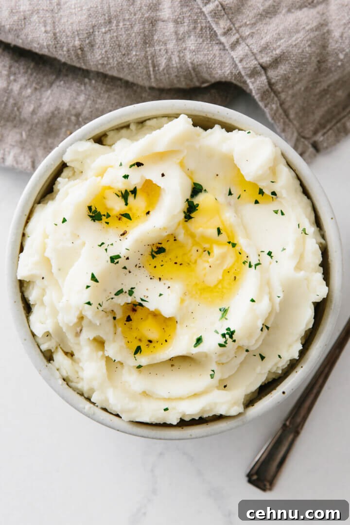Thanksgiving Menu Ideas and Classic Holiday Recipes 11 Mashed potatoes in a bowl topped with butter.