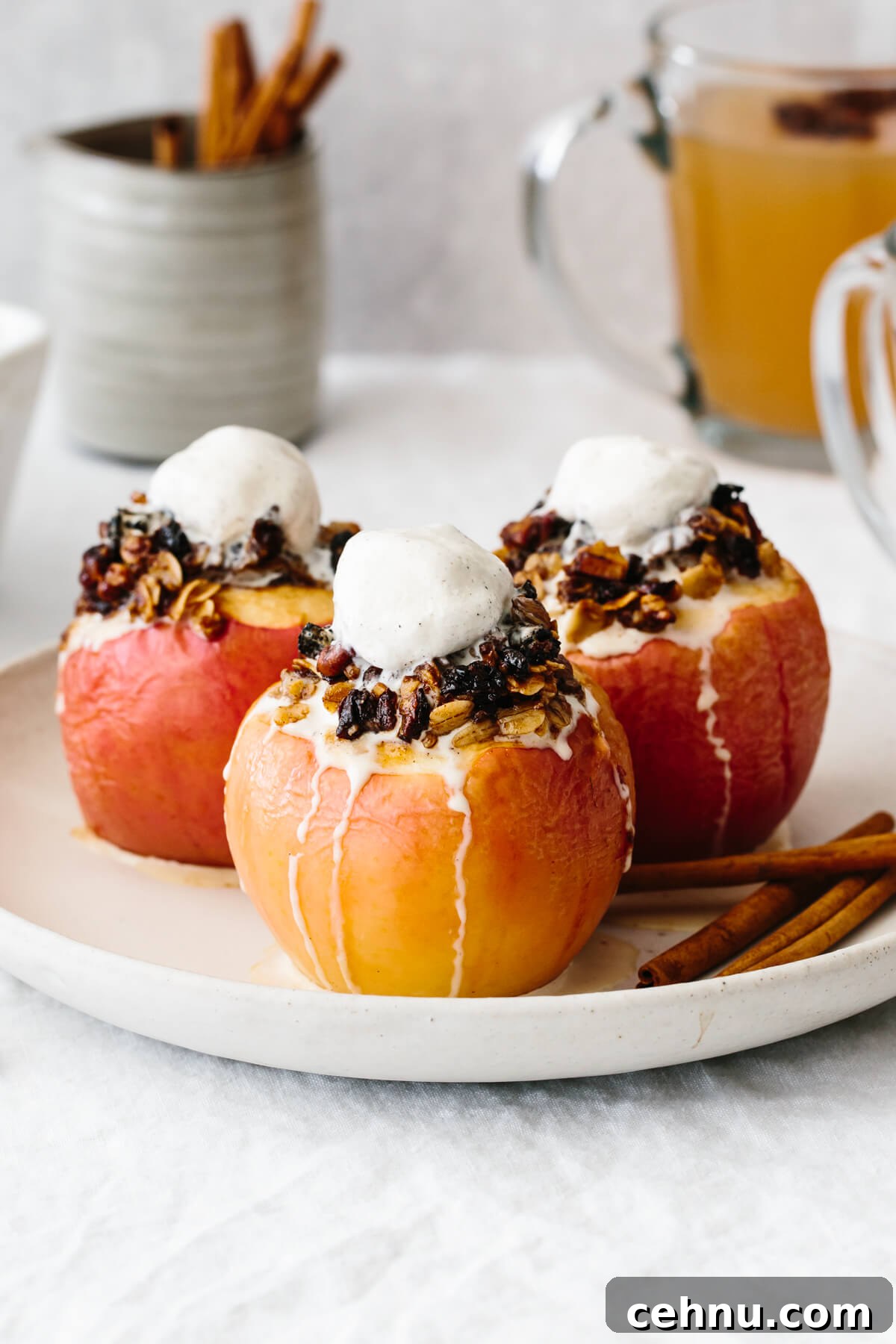 Thanksgiving Menu Ideas and Classic Holiday Recipes 17 Three baked apples on a plate with melted ice cream on top.