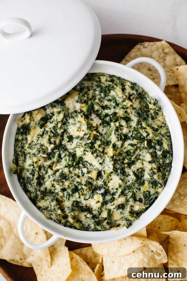 Thanksgiving Menu Ideas and Classic Holiday Recipes 4 Spinach artichoke dip in a white casserole dish.