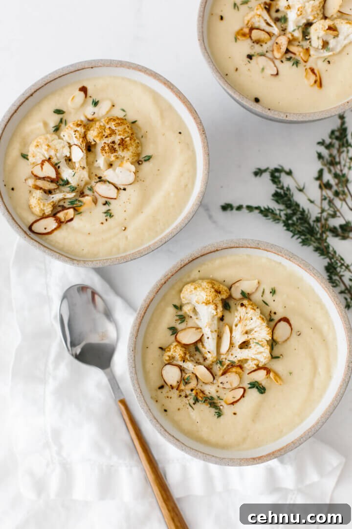 Thanksgiving Menu Ideas and Classic Holiday Recipes 8 Three bowls of roasted cauliflower soup on a table.