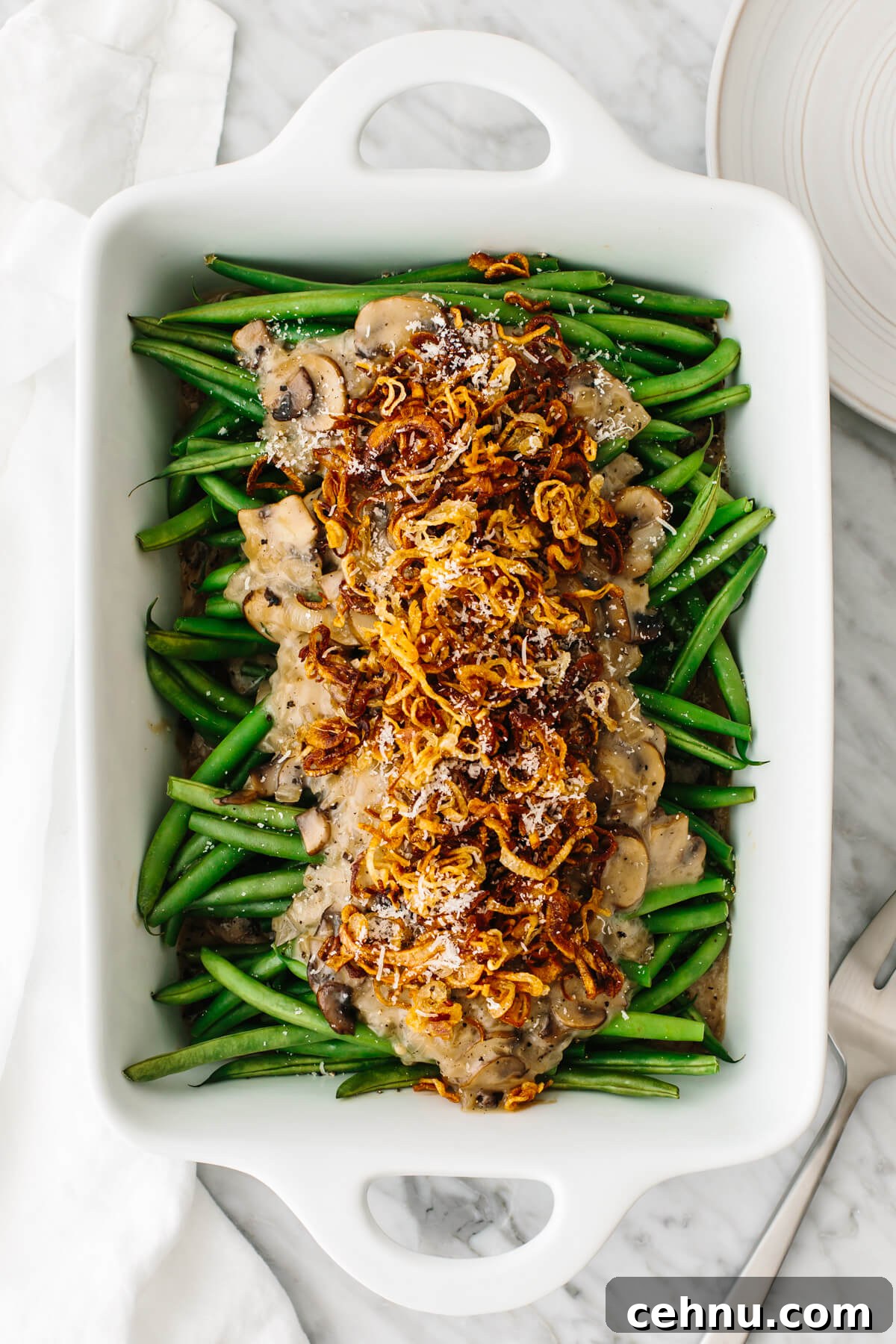 Thanksgiving Menu Ideas and Classic Holiday Recipes 9 A white dish with green bean casserole in it.