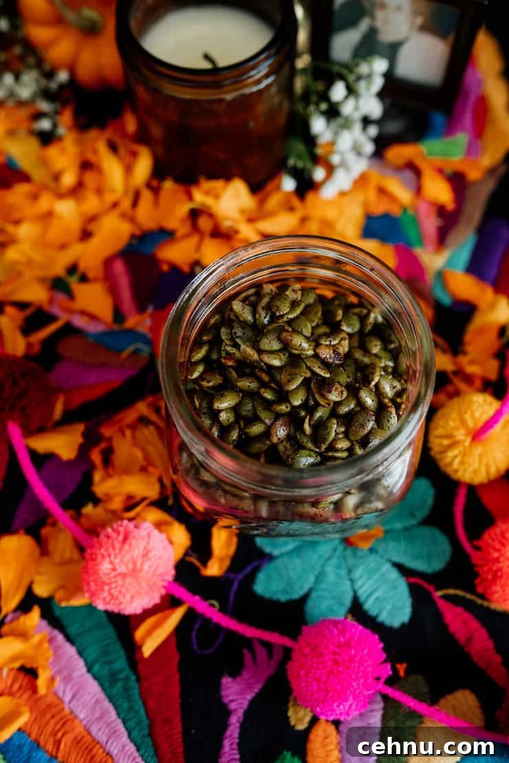How to Make Spicy Roasted Pepitas (Pumpkin Seeds) 6 spicy roasted pepitas in a mason jar on a table decorated with brightly colored embroidery