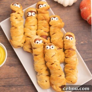 Air Fryer Mummy Hot Dogs: Halloween Appetizer Recipe 14 Golden crusted and wrapped hot dogs, to look like mummies with candy eyes