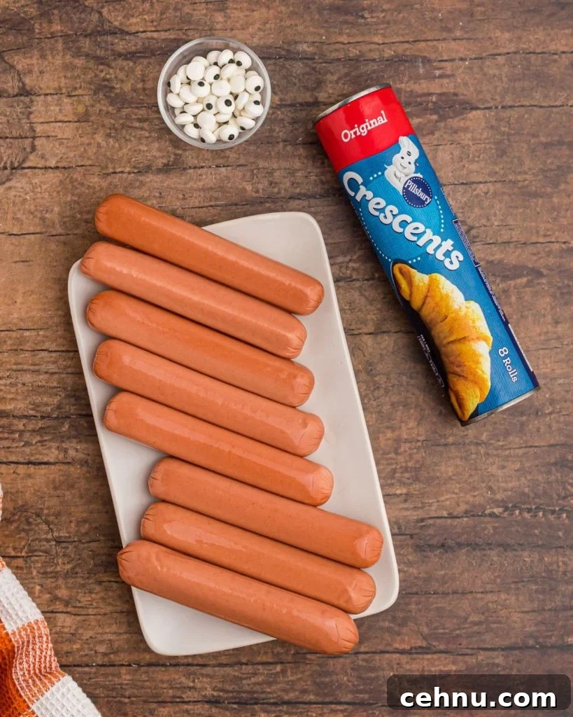 Air Fryer Mummy Hot Dogs: Halloween Appetizer Recipe 4 Ingredients for mummy dogs. Hot dogs, crescent rolls, and candy eyes.