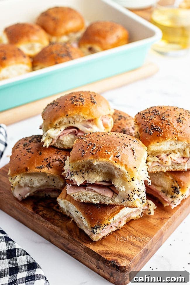 Ham and Swiss Sliders Recipe with Honey Mustard Glaze 2 sliders on a wood tray with black check napkin