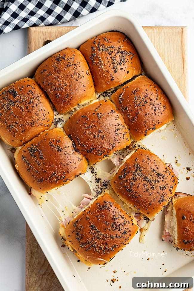 Ham and Swiss Sliders Recipe with Honey Mustard Glaze 3 baked sliders in pan on counter