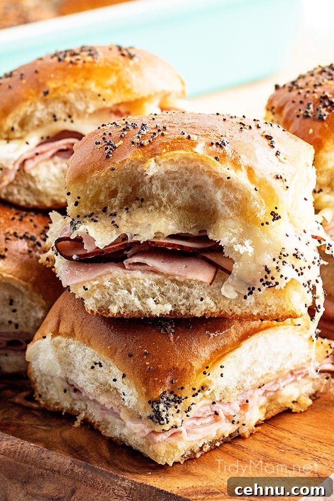 Ham and Swiss Sliders Recipe with Honey Mustard Glaze 5 ham sliders stacked and on a wood tray