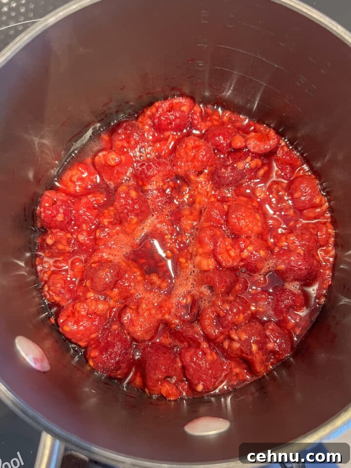 cooked raspberries in a black saucepan