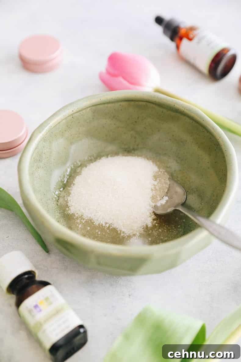 DIY Sugar Lip Scrub Recipe for Soft, Smooth Lips 3 Ingredients for DIY Lip scrub in a green bowl. Sugar and coconut oil with lavender essential oil and vitamin E oil
