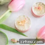 DIY Lip scrub in a small pink metal tin with pink tulips.