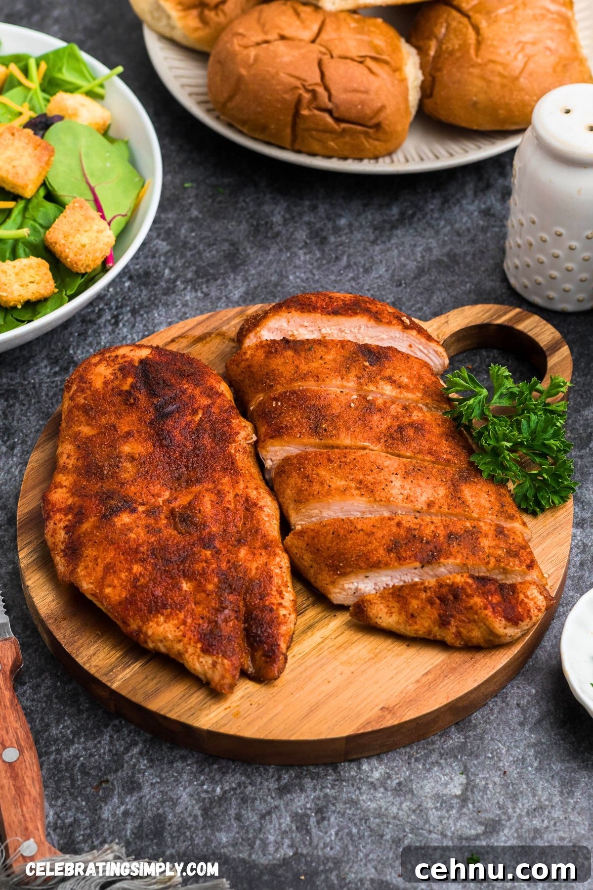 Seasoned smoked chicken resting a wooden cutting board. 