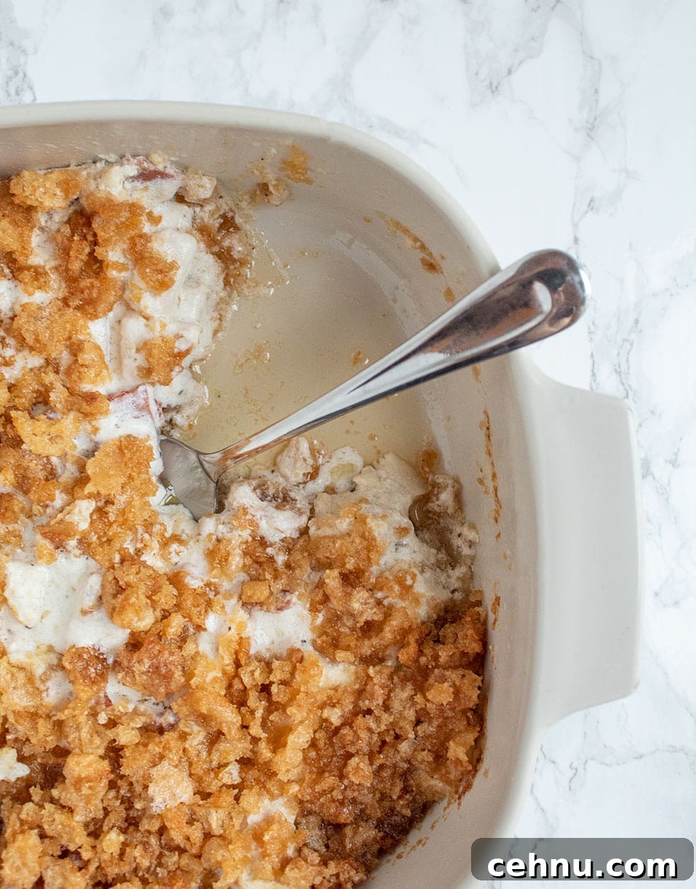 keto casserole dish with piece missing and butter on the bottom