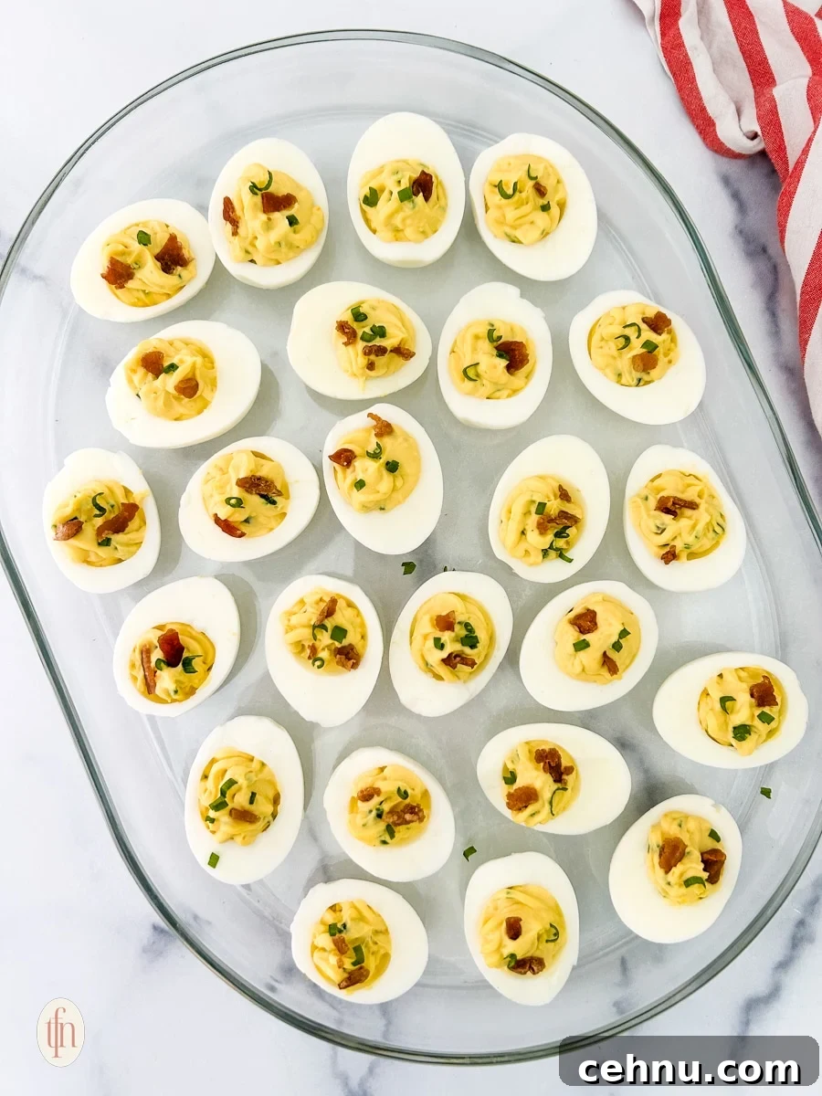 jalapeno deviled eggs on a glass serving dish.
