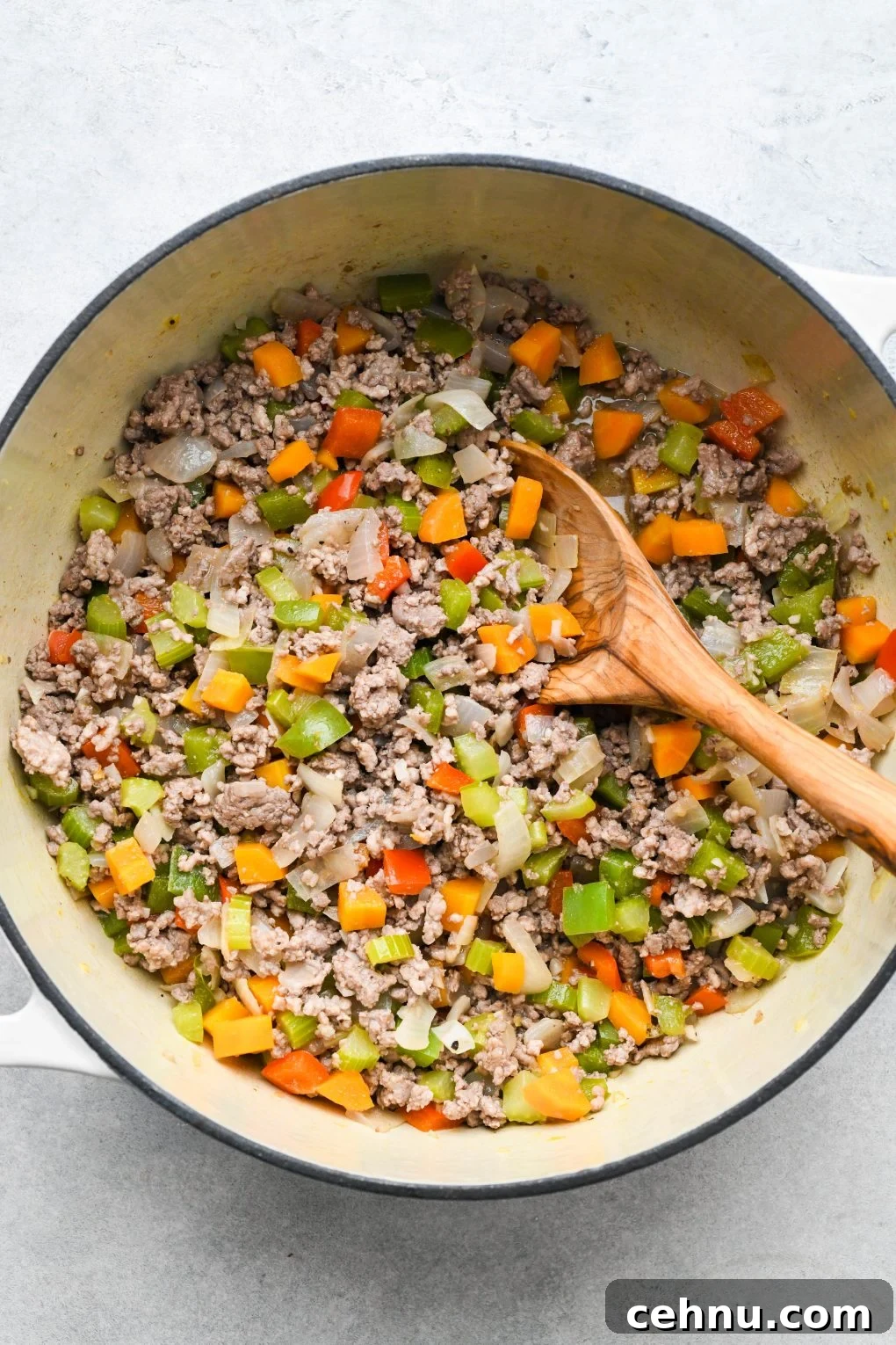 Veggies and meat cooked in a large soup pot.