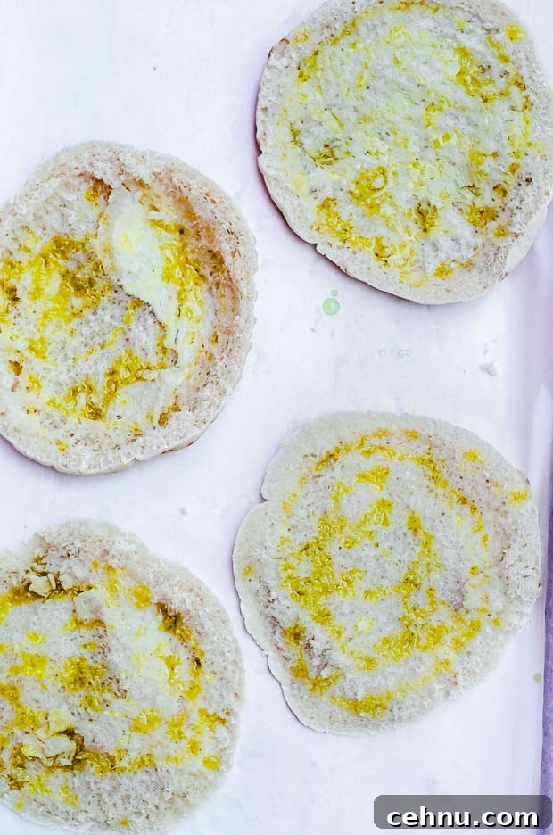 Pita bread halves with olive oil on a baking sheet ready to be baked for fattoush salad