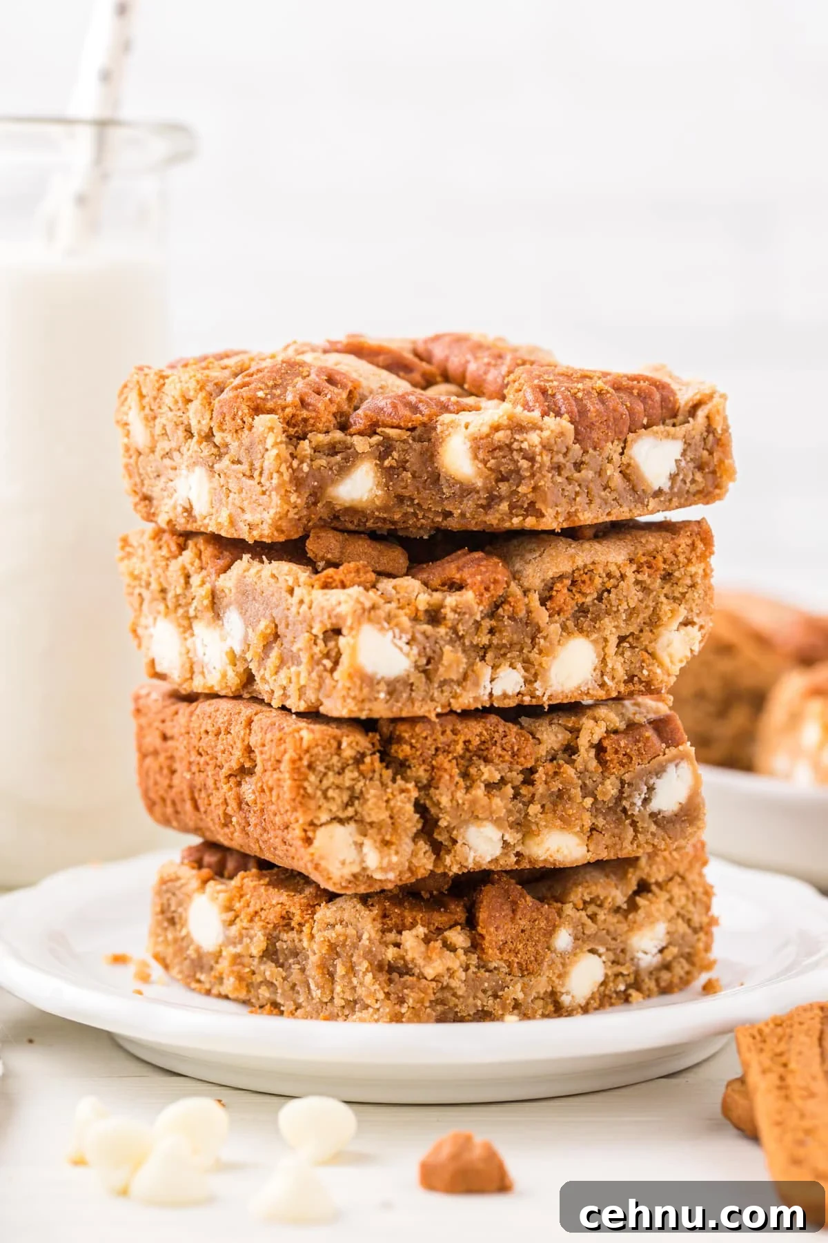 A stack of blondies with white chocolate chips.
