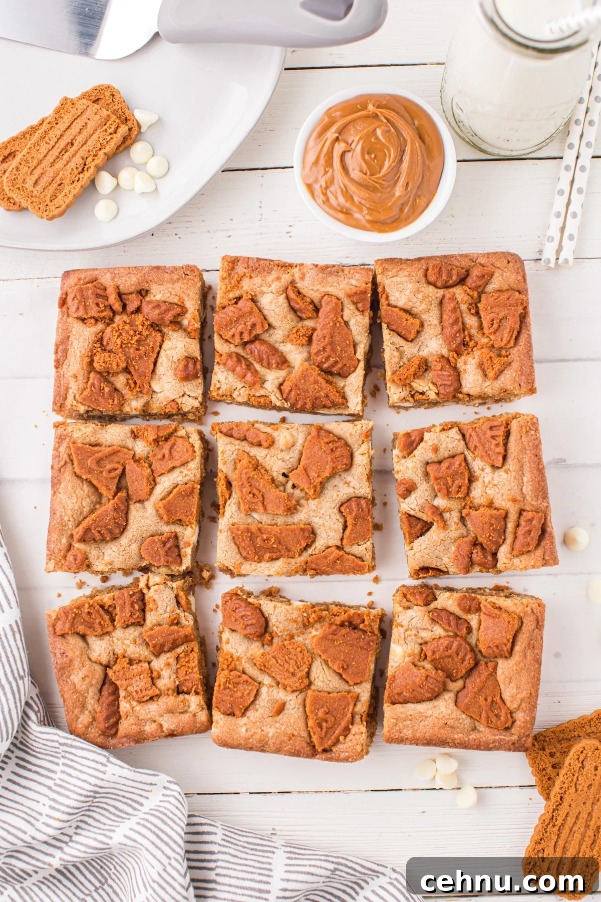 Biscoff blondies cut into squares, topped with biscoff cookies.