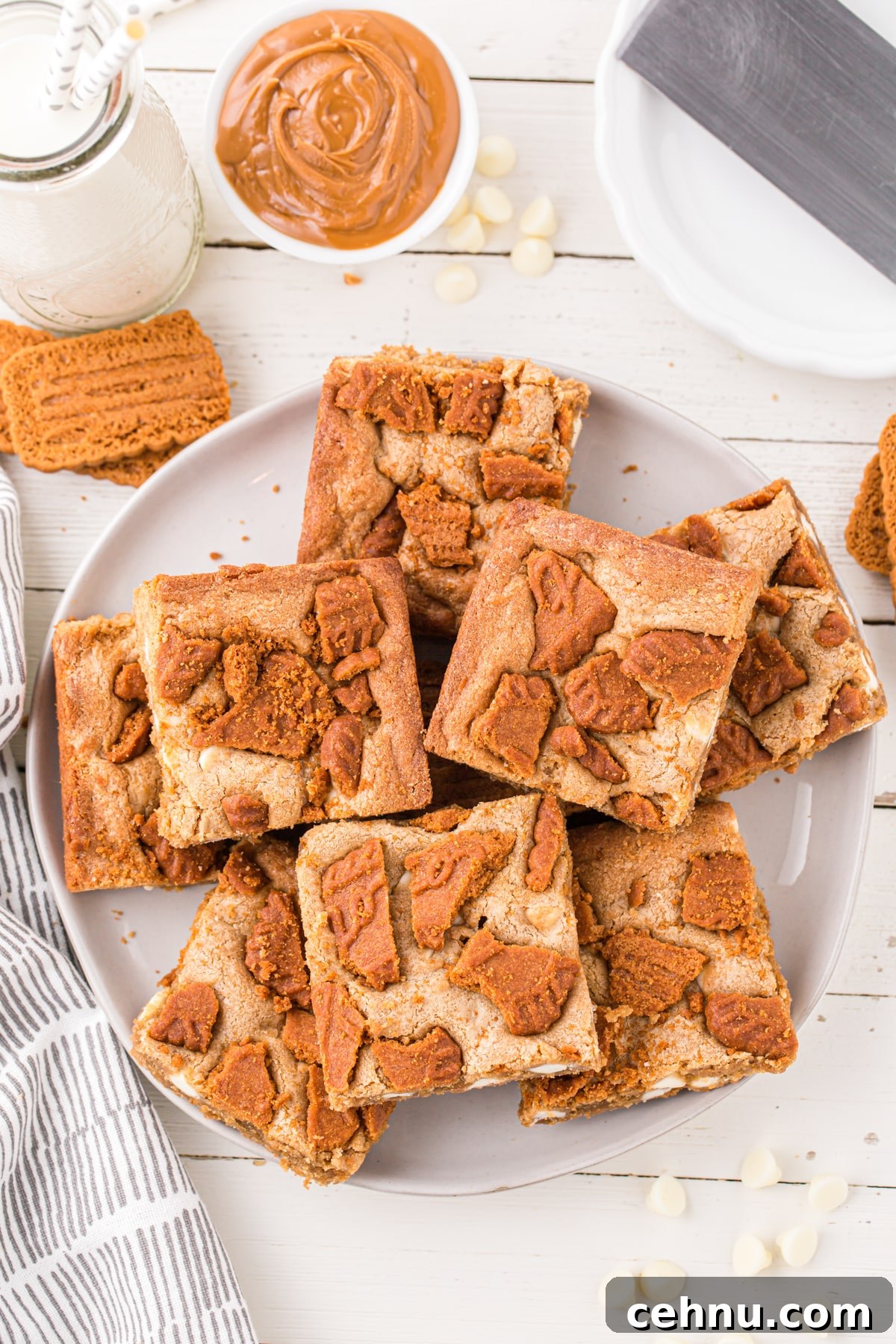 A plate of blondies topped with biscoff cookies.