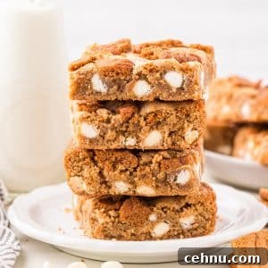 A stack of blondies filled with white chocolate chips.