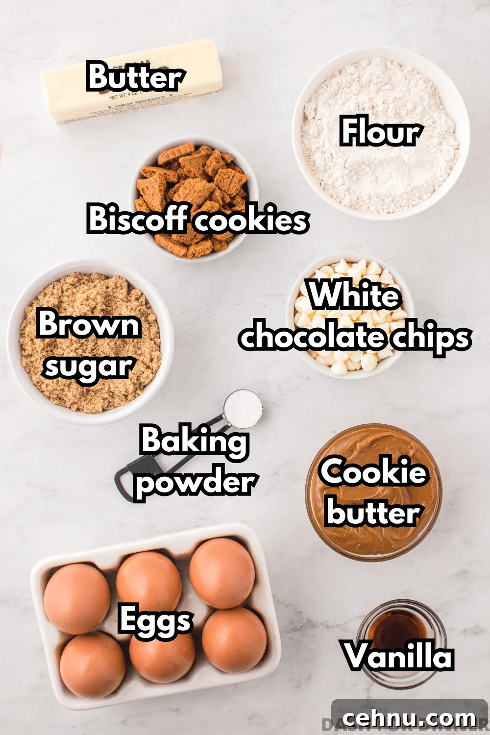 The ingredients needed to make cookie butter blondies: biscoff cookies, eggs, flour, brown sugar, cookie butter, etc.
