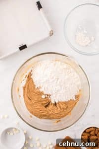 Adding flour to blondie batter.