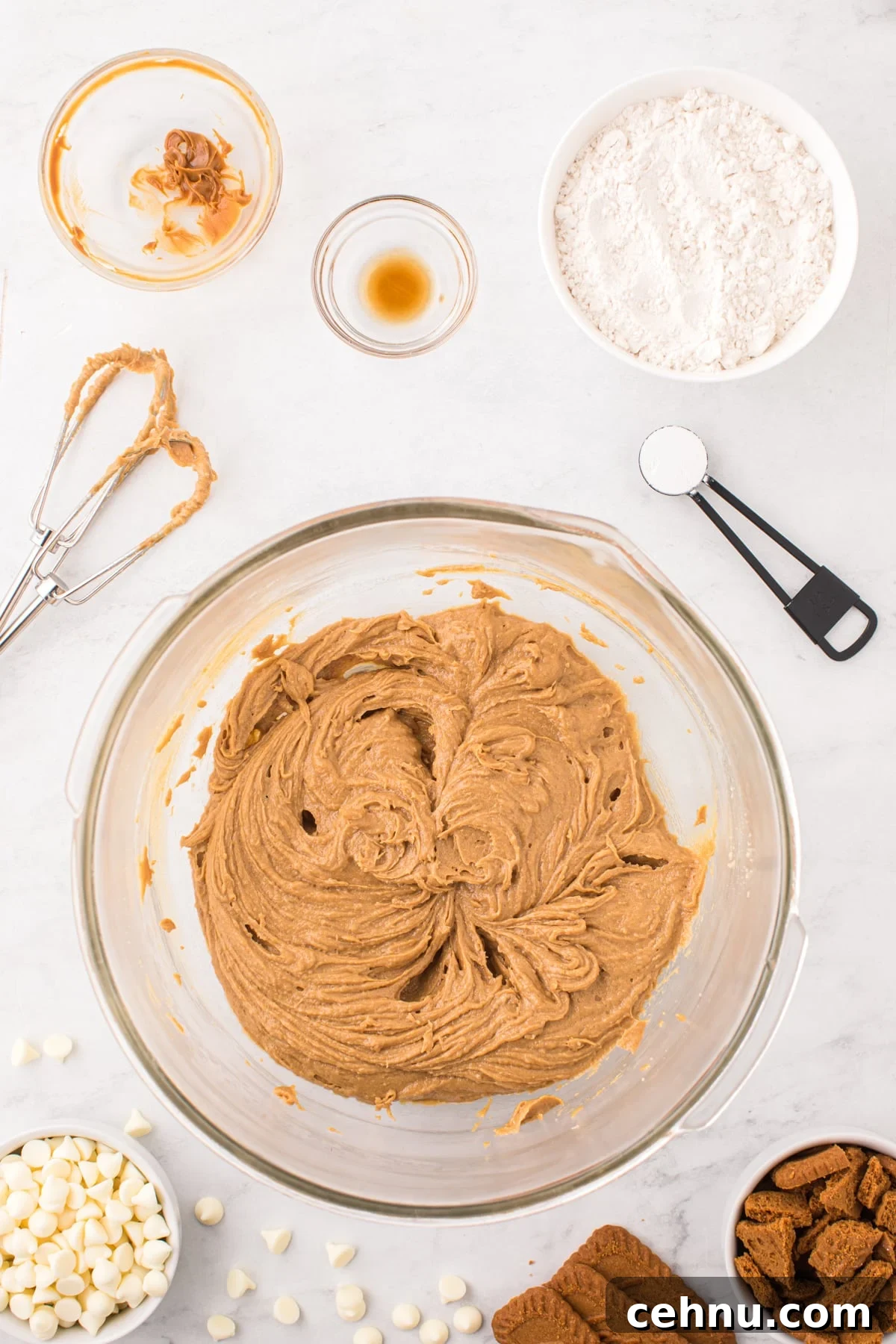 A bowl with creamed butter, sugar, egg, and cookie butter.