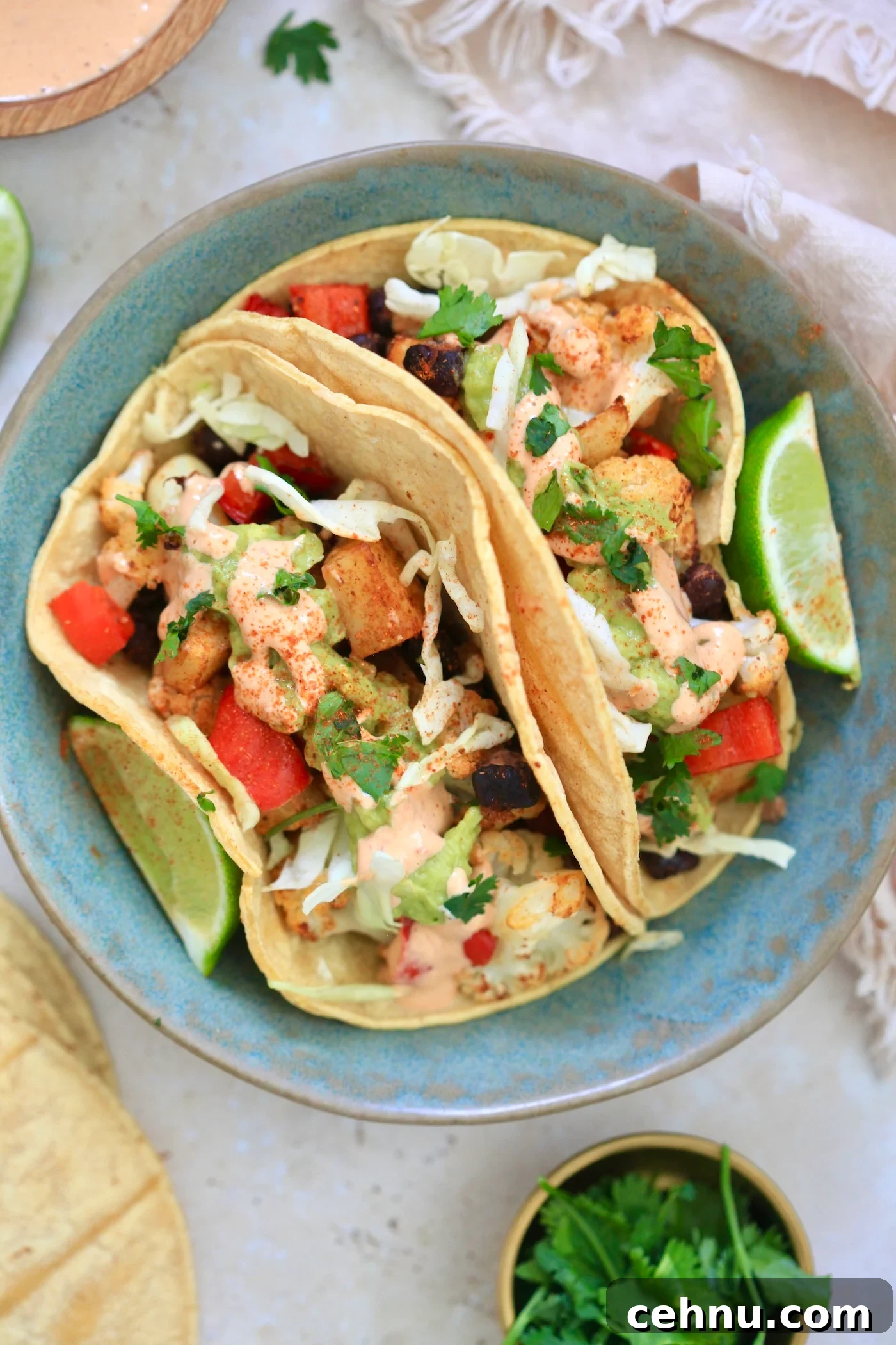 blue bowl with veggie-stuffed tacos in it.