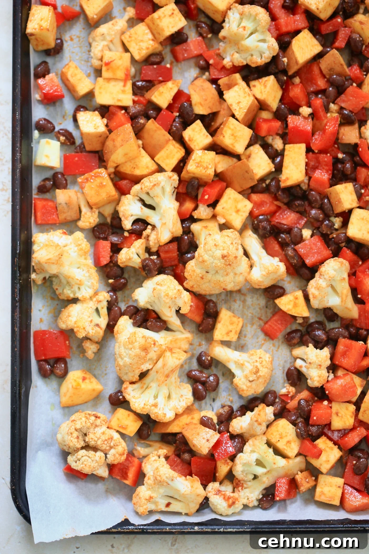 cauliflower, beans, and peppers on baking sheet