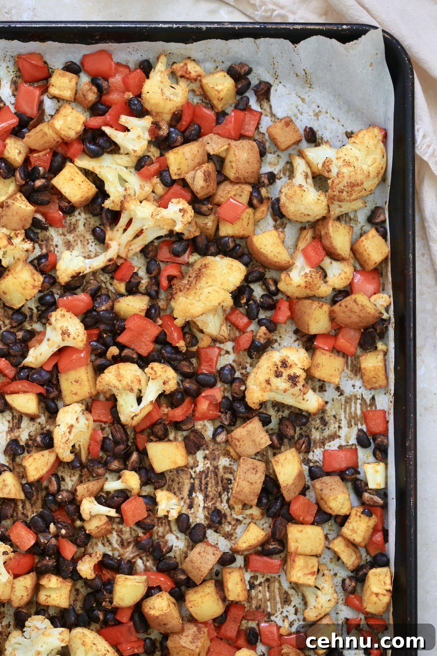 cooked veggies and beans on baking sheet
