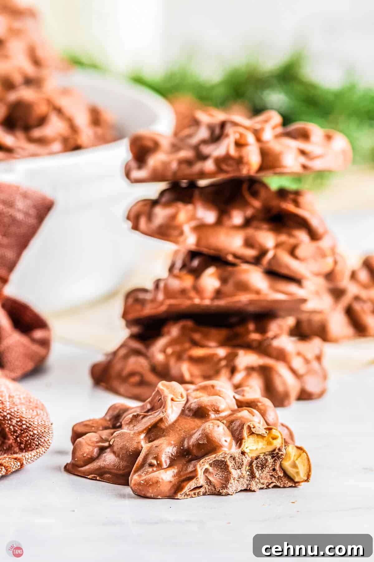 Slow Cooker Peanut Clusters: No-Bake Candy Recipe 11 close up of chocolate candy on parchment paper