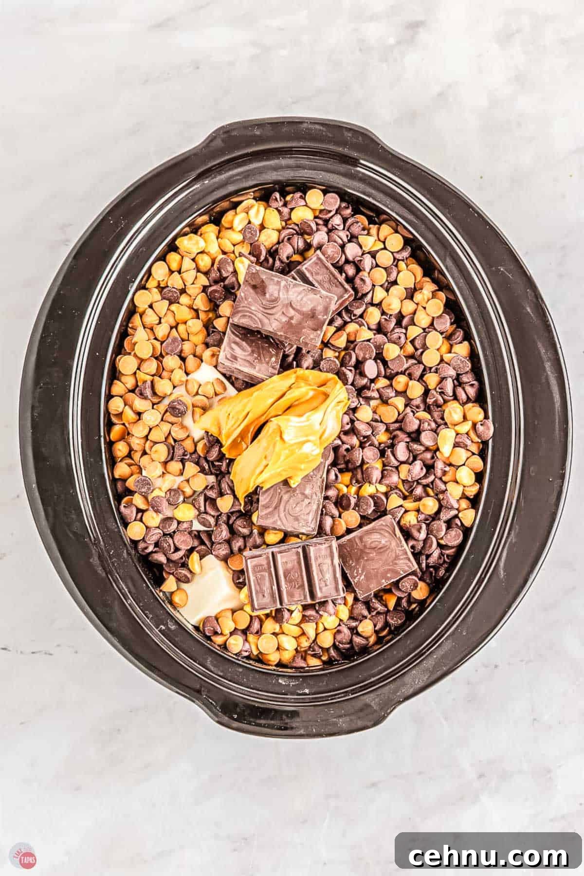 Slow Cooker Peanut Clusters: No-Bake Candy Recipe 4 crockpot with peanuts, chocolate chips, and peanut butter in it