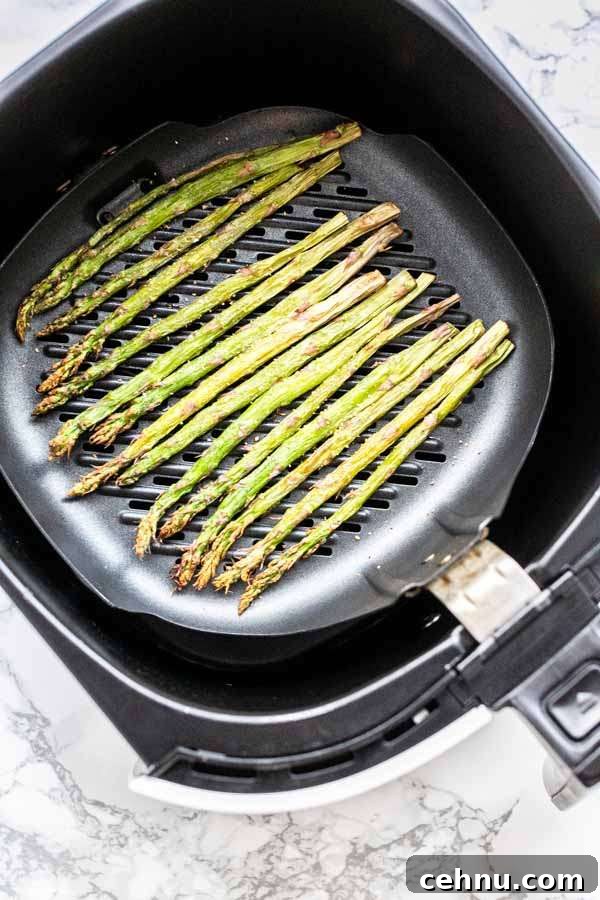 Fresh asparagus spears on a grill pan in the Air Fryer
