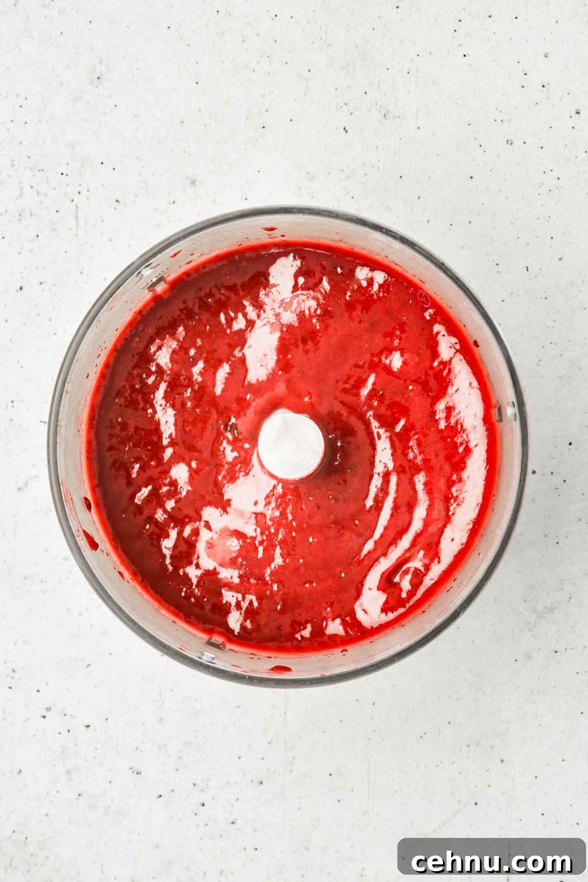 food processor bowl with strawberry compote for cinnamon rolls