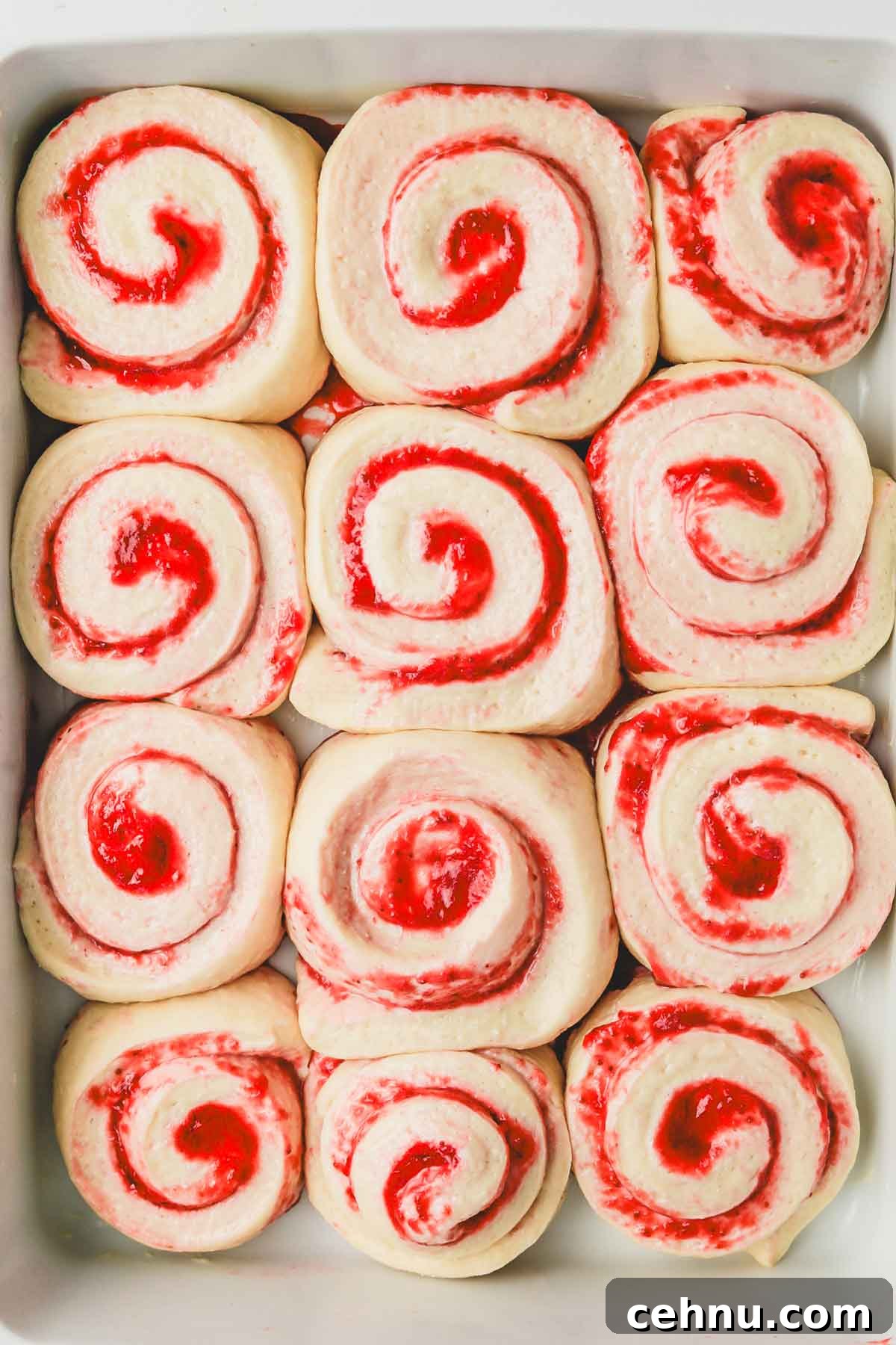 strawberry cinnamon rolls after the second rise in baking dish